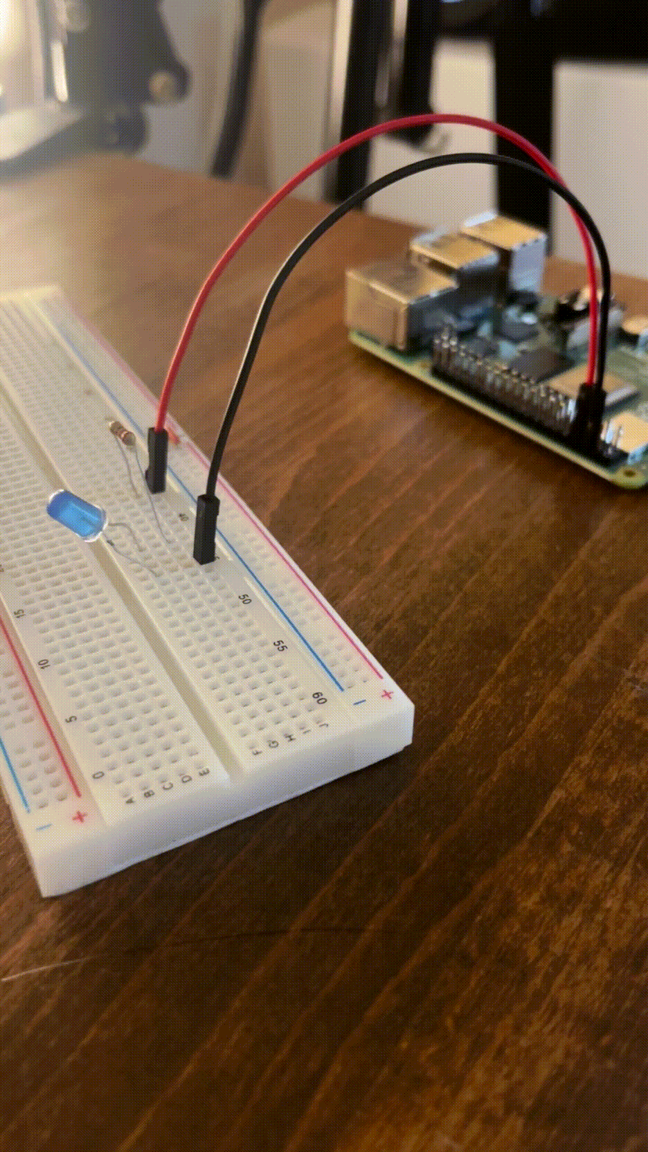 A GIF of the completed project showing a blinking blue LED connected to a Raspberry Pi with jumper cables.